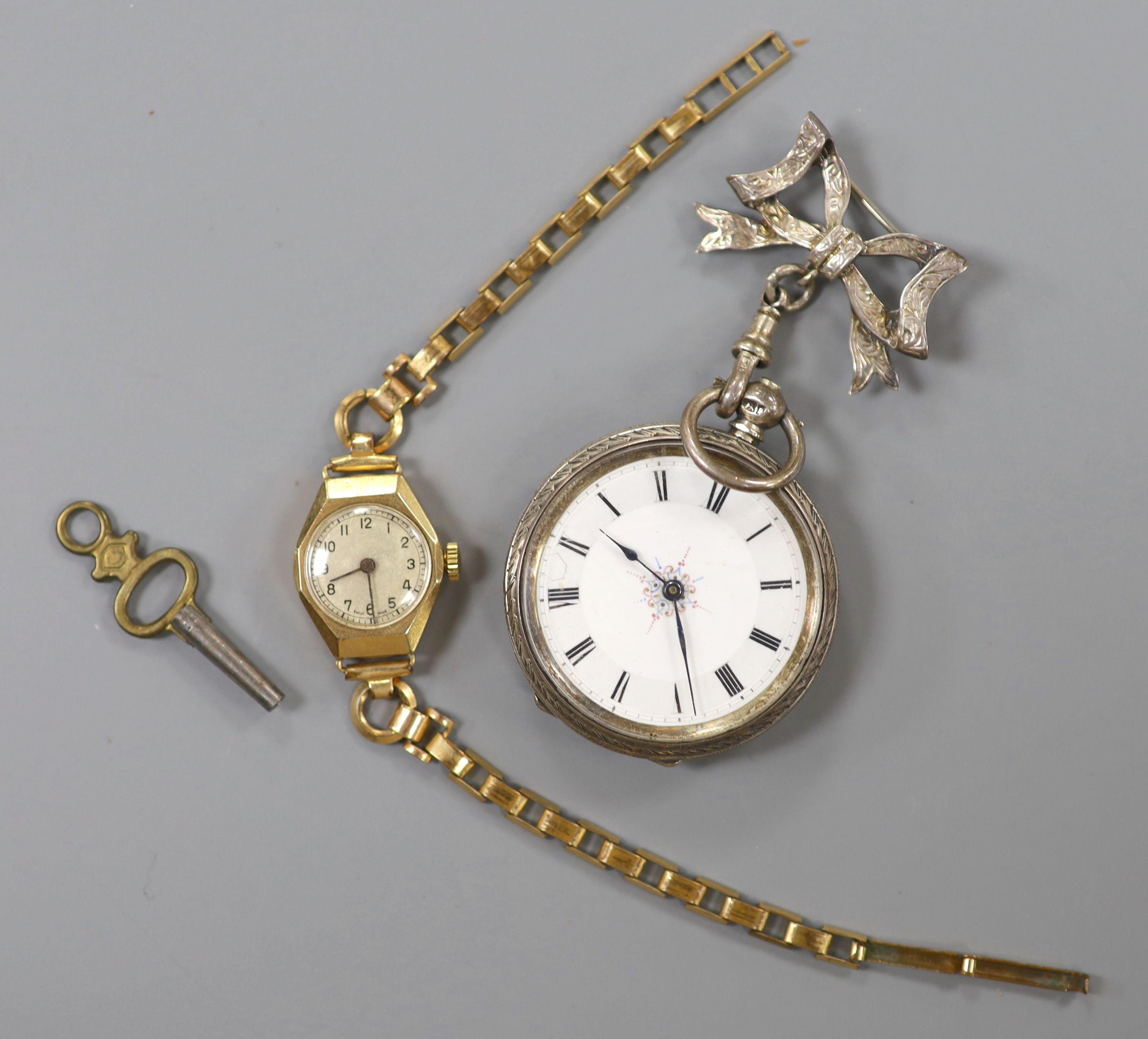 A lady's yellow metal manual wind wrist watch, on a gold plated bracelet, together with a silver fob watch.